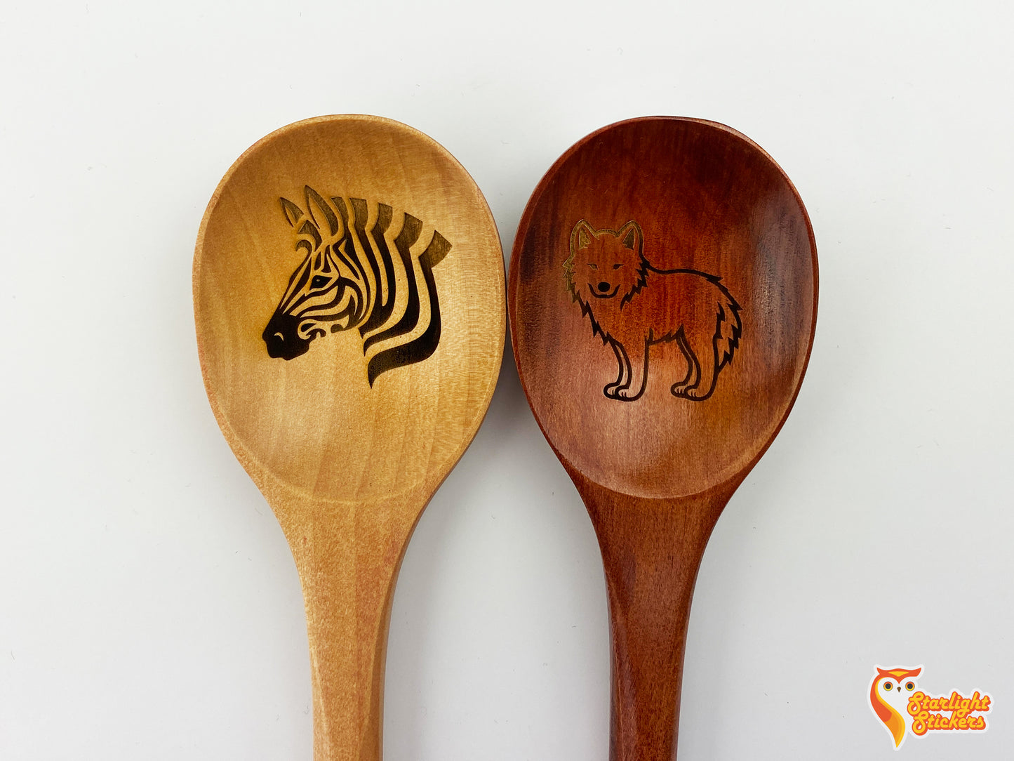 Close up of the engraved light wood and dark wood spoons.