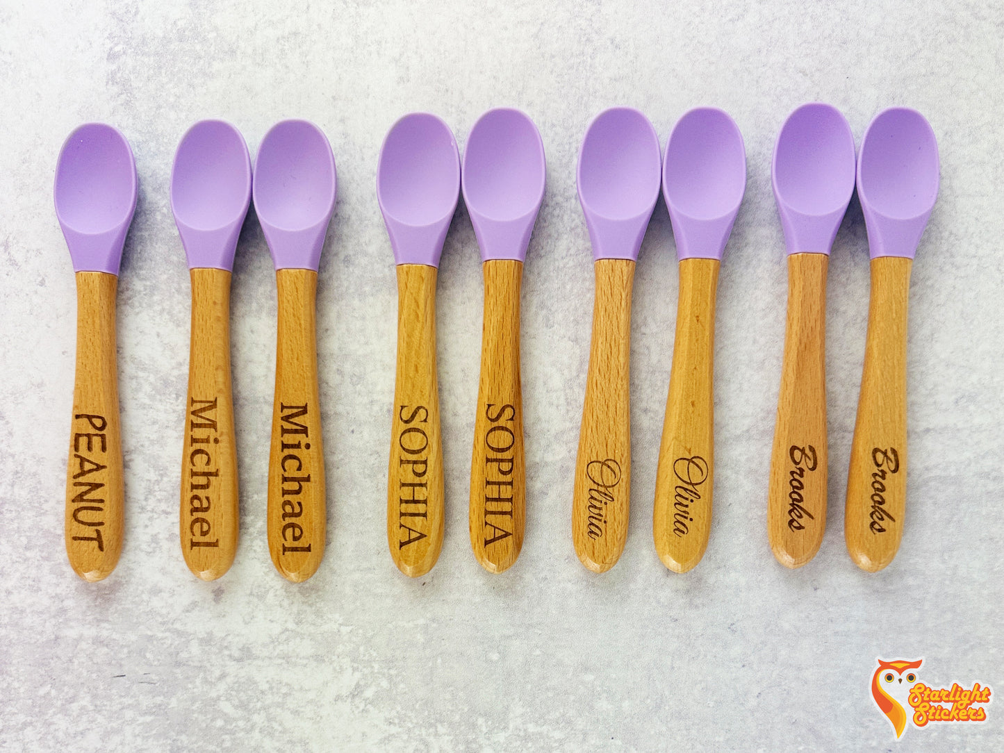 9 Baby spoons with different fonts and names engraved on the handles.