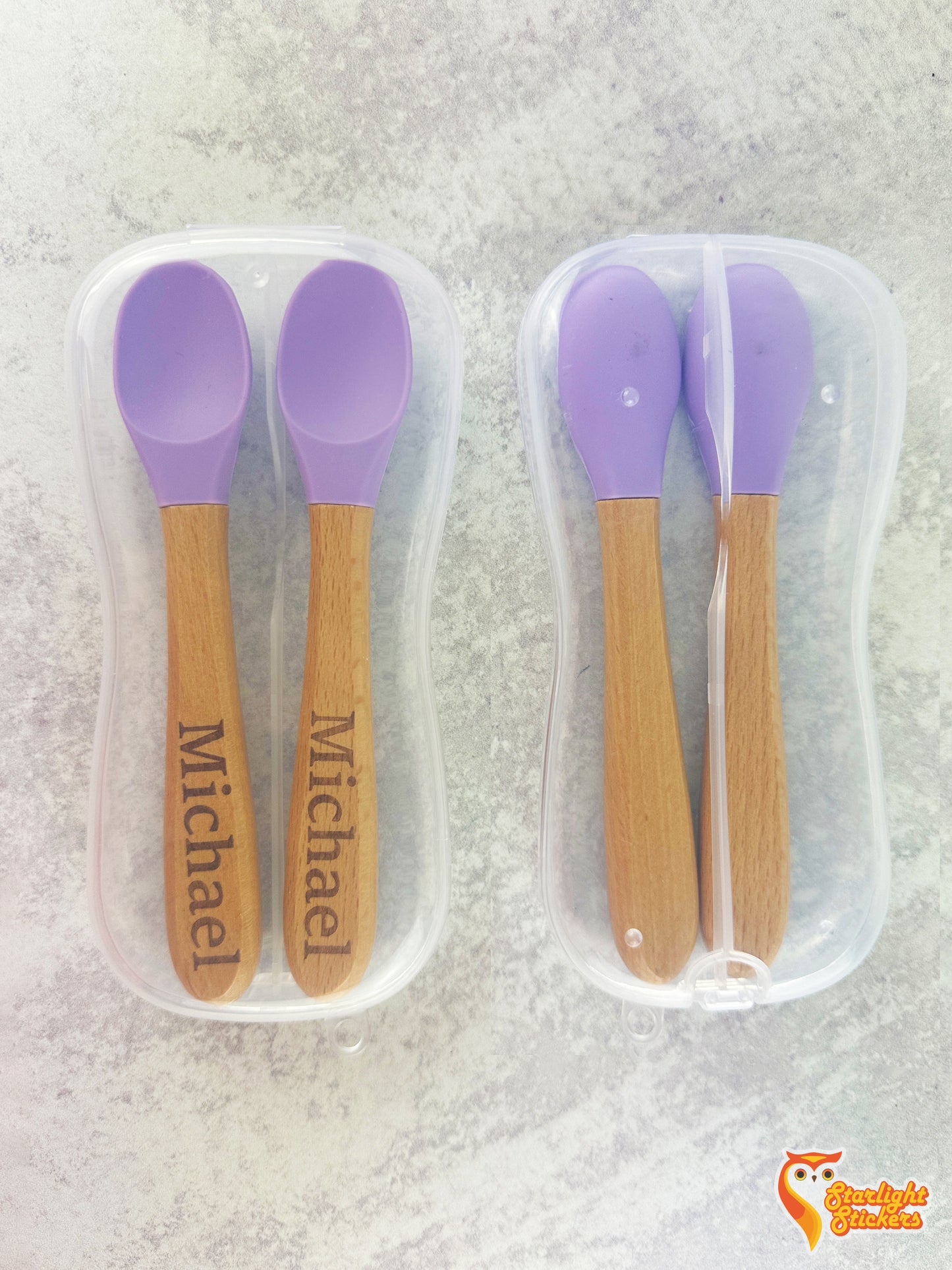 Front and back of baby spoons in a clear plastic travel case.