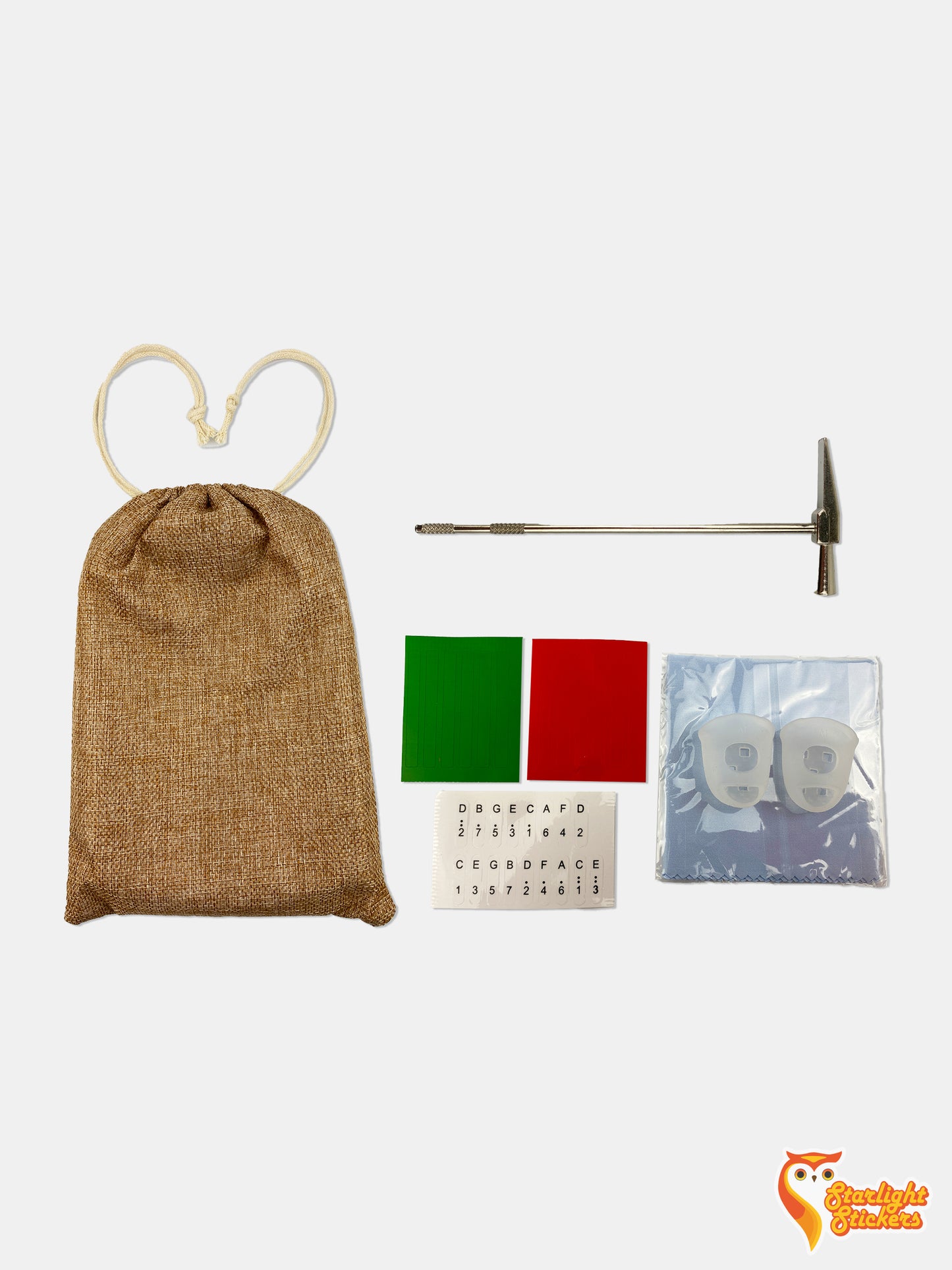 All package accessories, including a tuner, kalimba bag, note stickers, thumb sleeves, and a microfiber cloth.