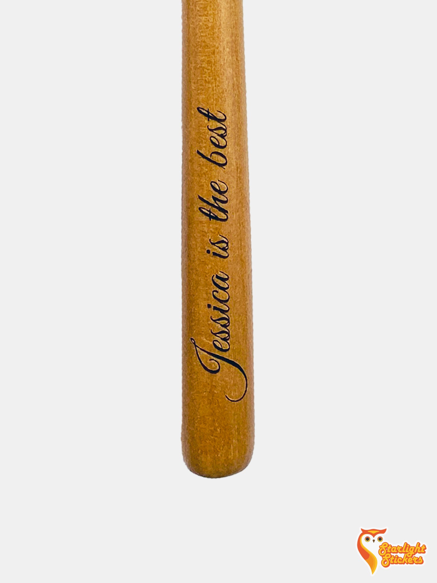 "Jessica is the best" engraved in the handle of a lightwood handle.