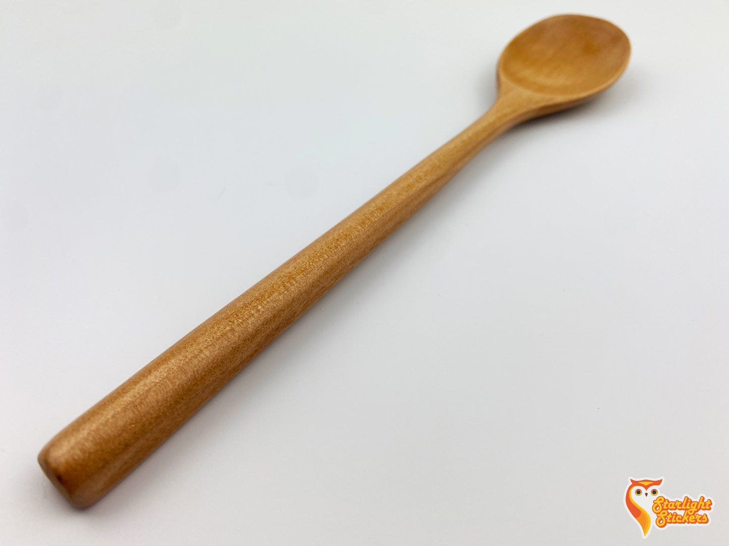 Close up of a light wood spoon handle.