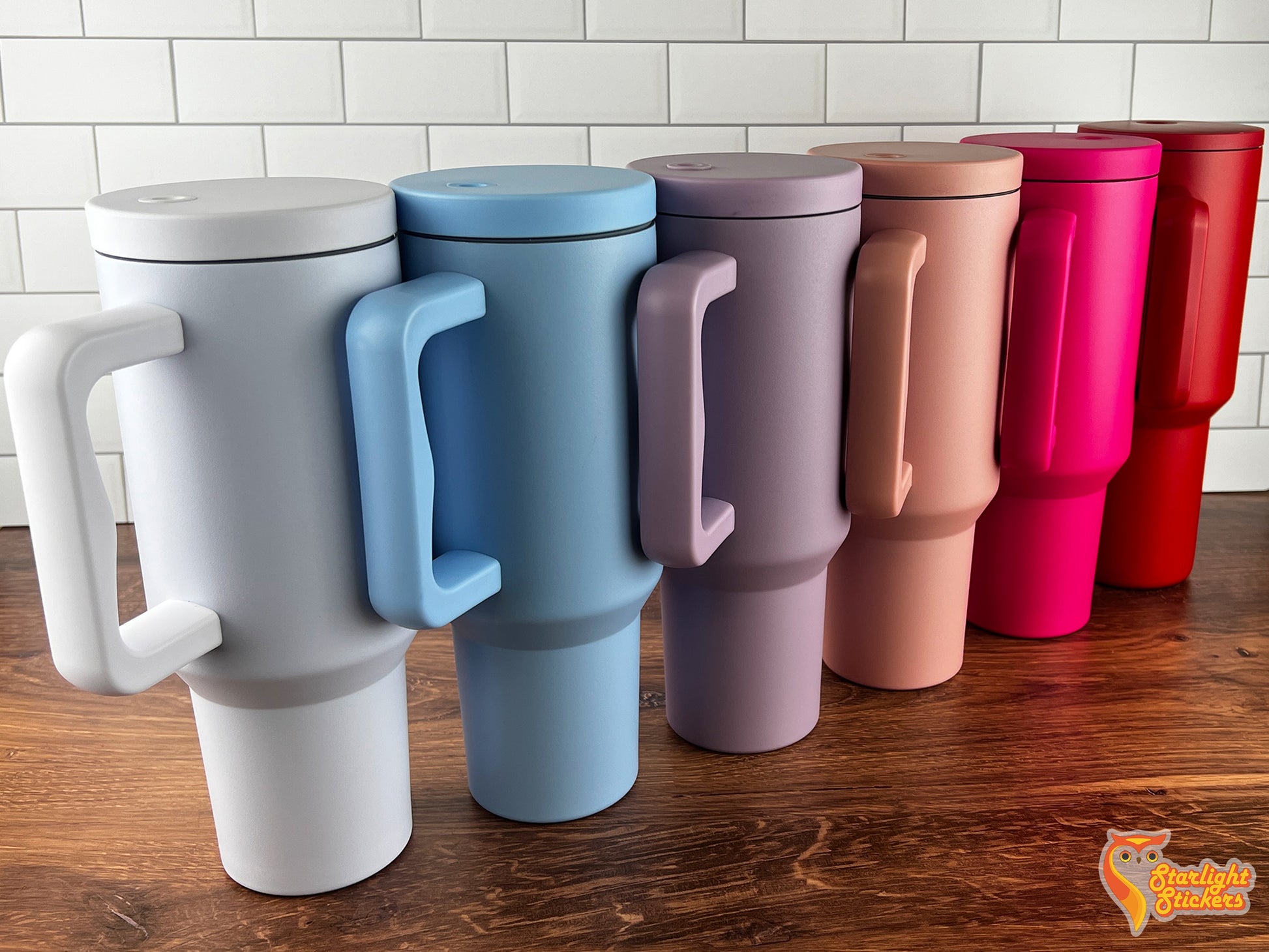 Color options of; White, Light blue, Lavender, Rose pink, Hot pink, and red lined up next to each other on a wooden table.