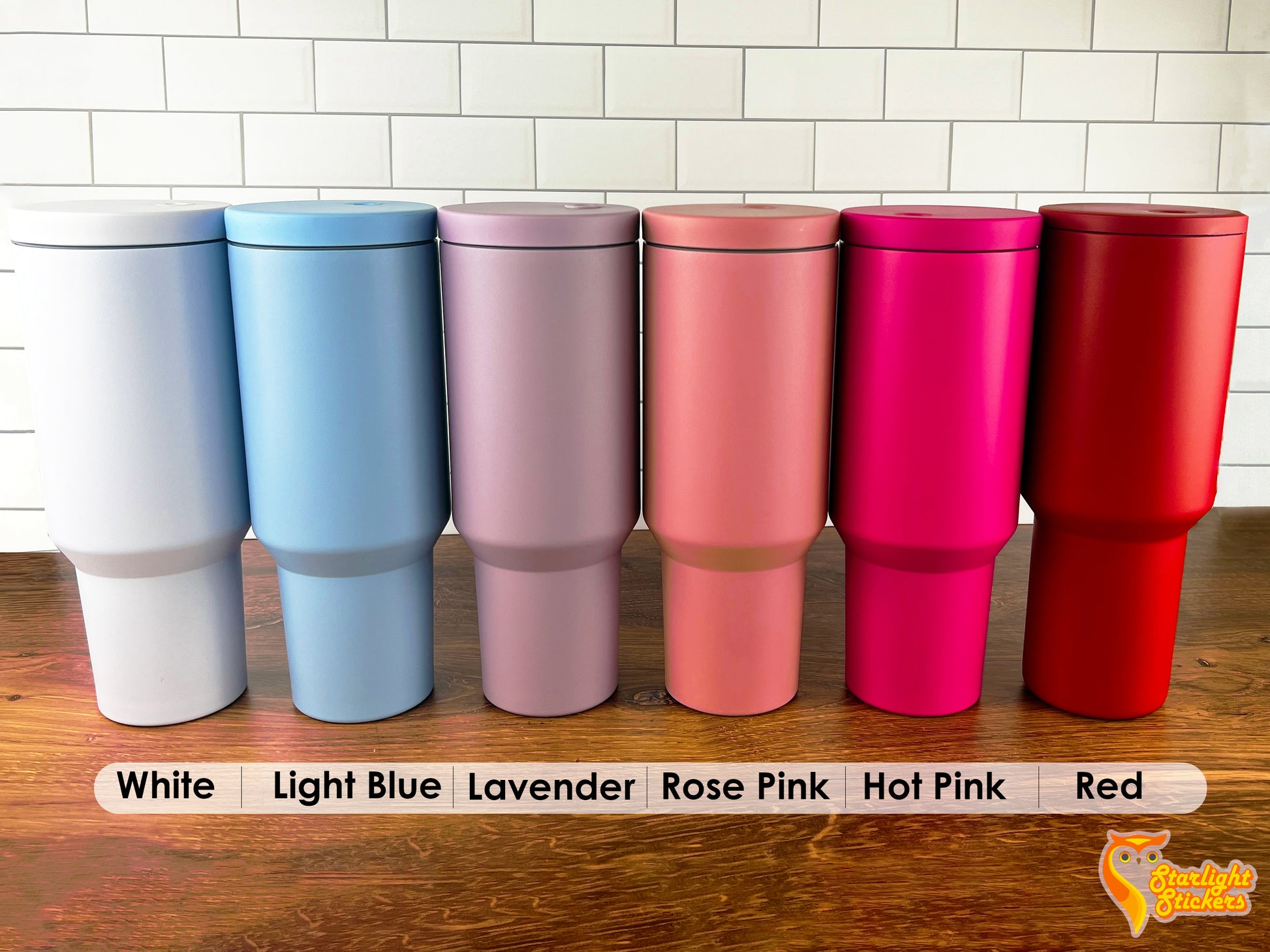Color options of; White, Light blue, Lavender, Rose pink, Hot pink, and red lined up next to each other on a wooden table.