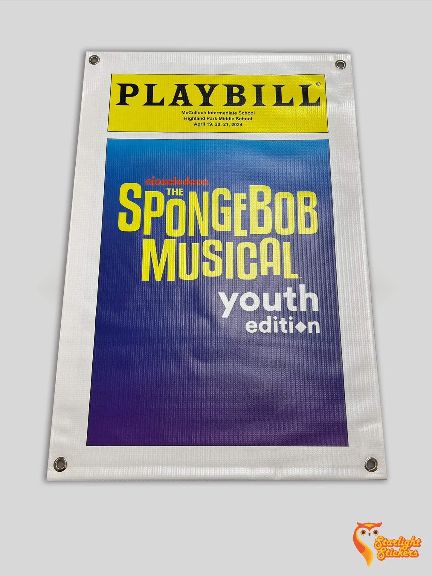 Banner of a nickelodeon musical on a white table.