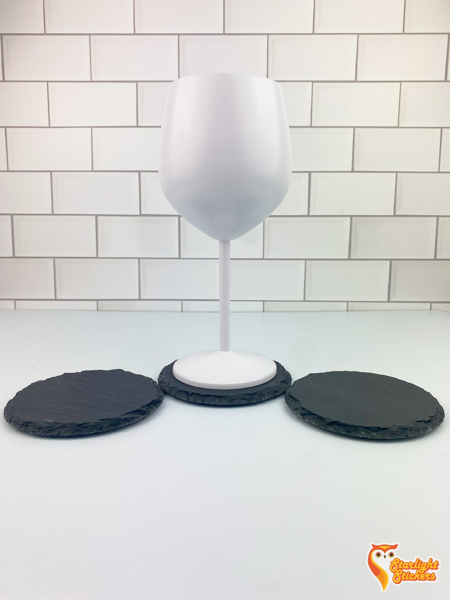 White whine glass resting on top of circular coaster.