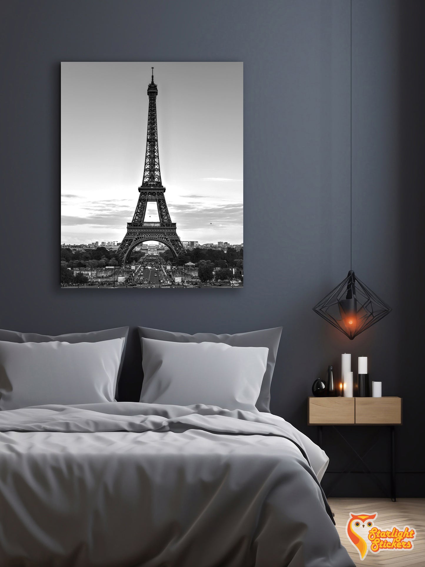 Poster of the Eiffel Tower above a bed in a bedroom.