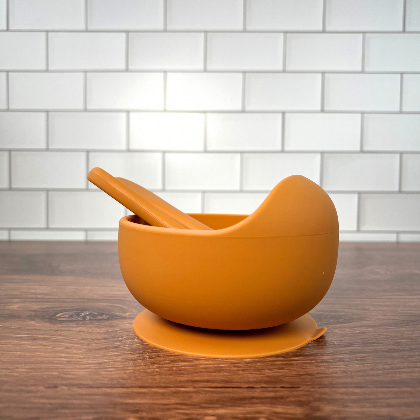 Orange bowl set on a wooden table.