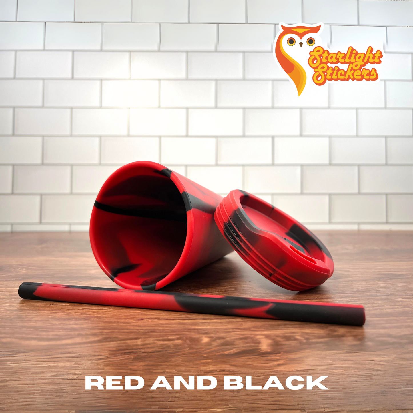 Red and black cup on a wooden table.