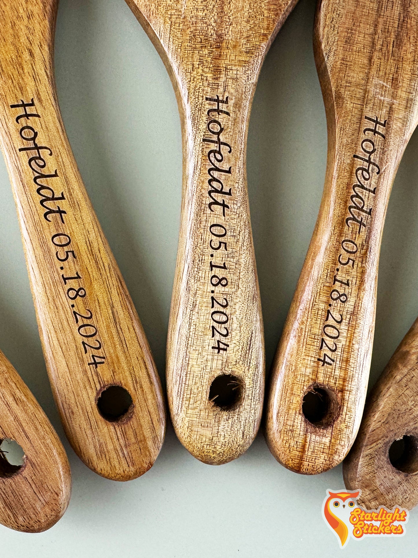 Close up of the engraved handles of 3 spurtles.