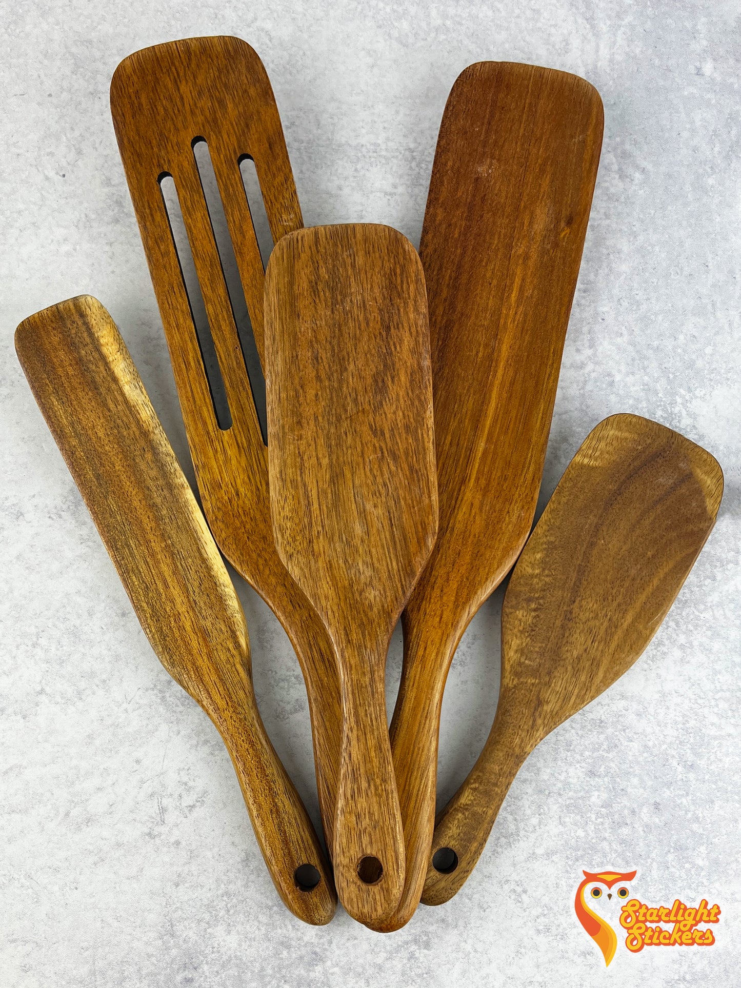 A spurtle set on a marble background.