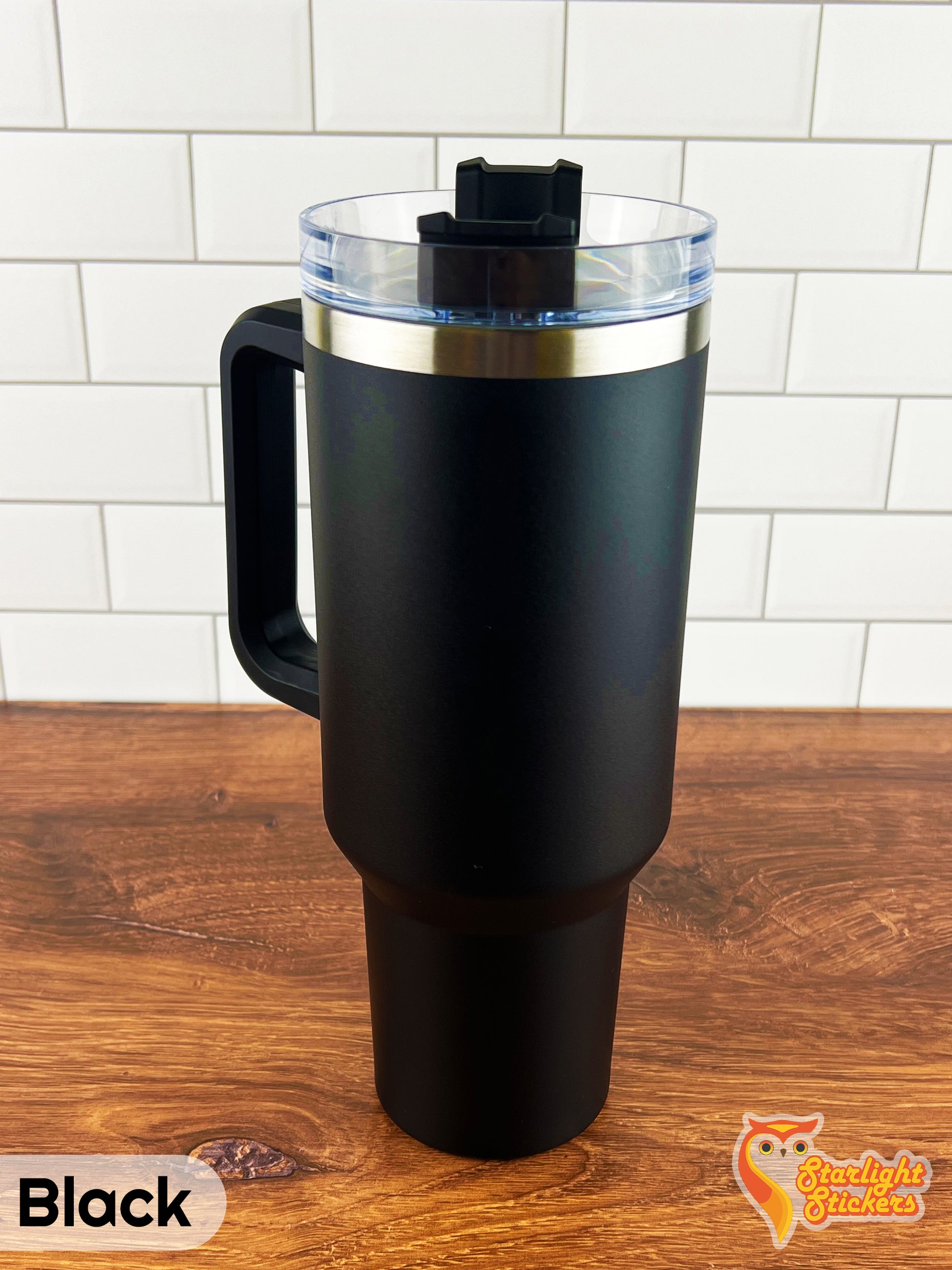 Black tumbler on a wooden table.