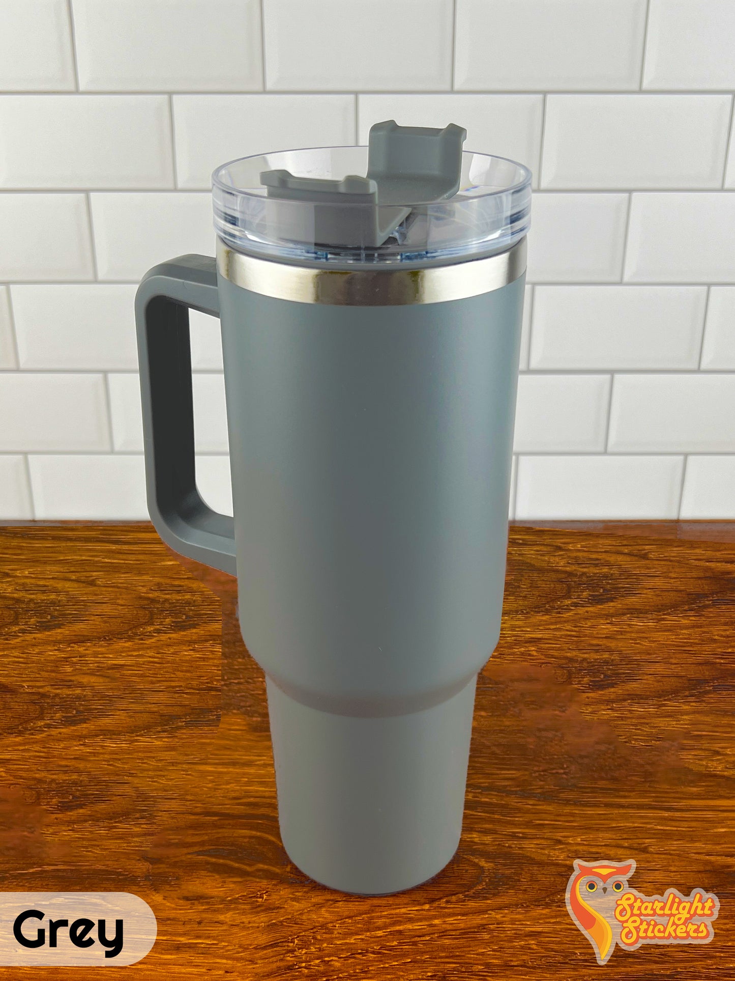 Grey tumbler on a wooden table.