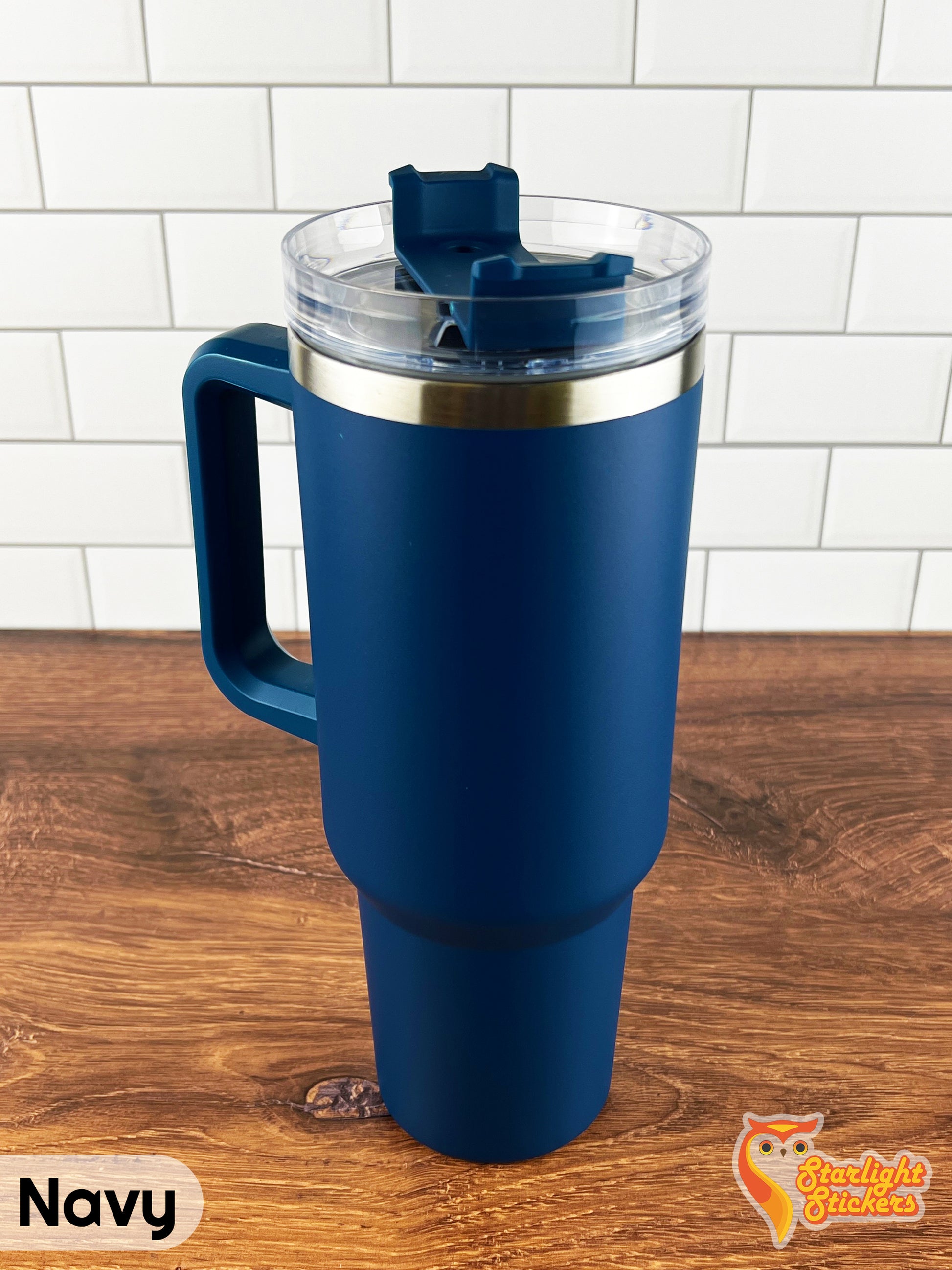 Navy tumbler on a wooden table.