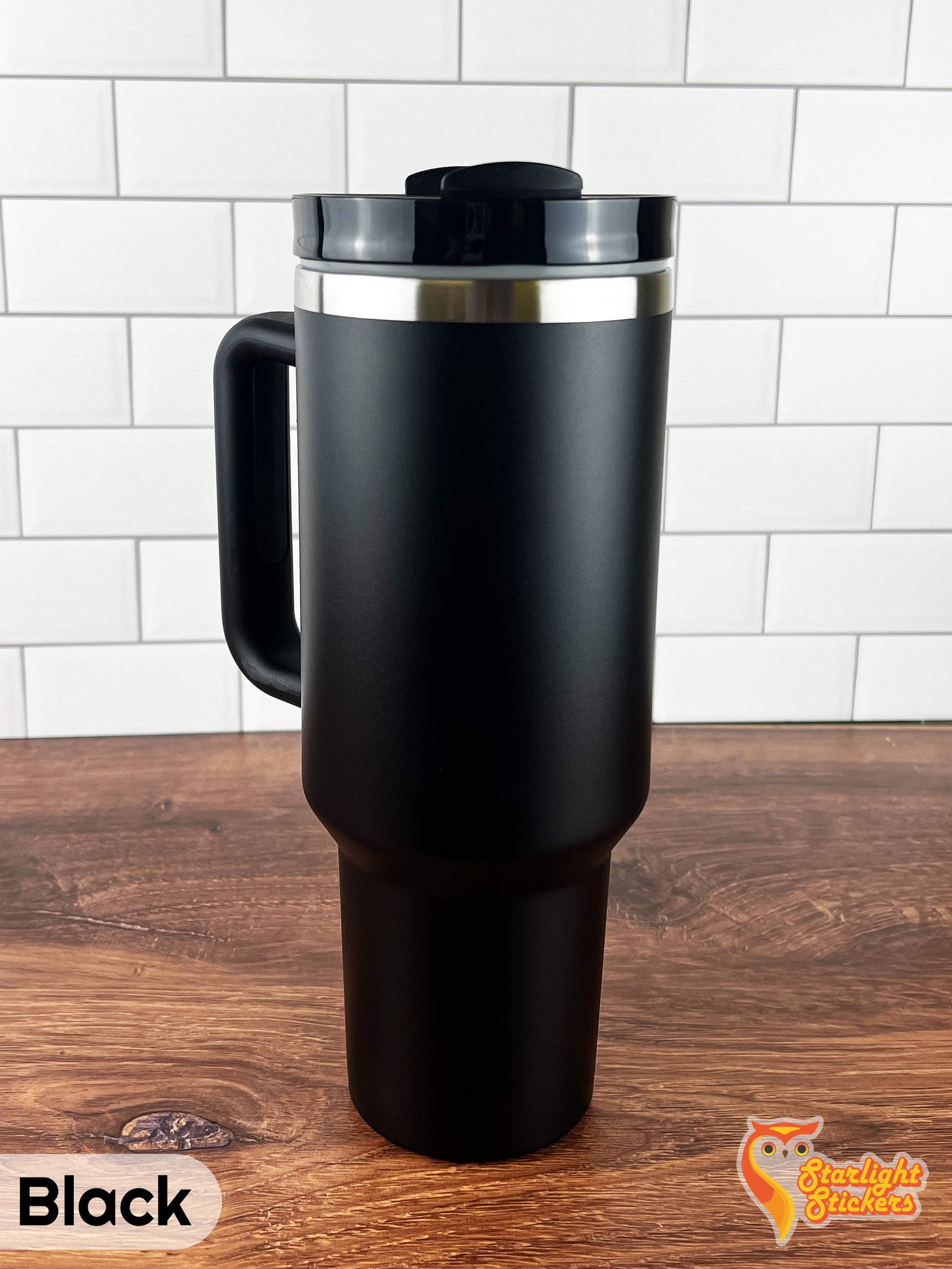 Black tumbler on a wooden table.