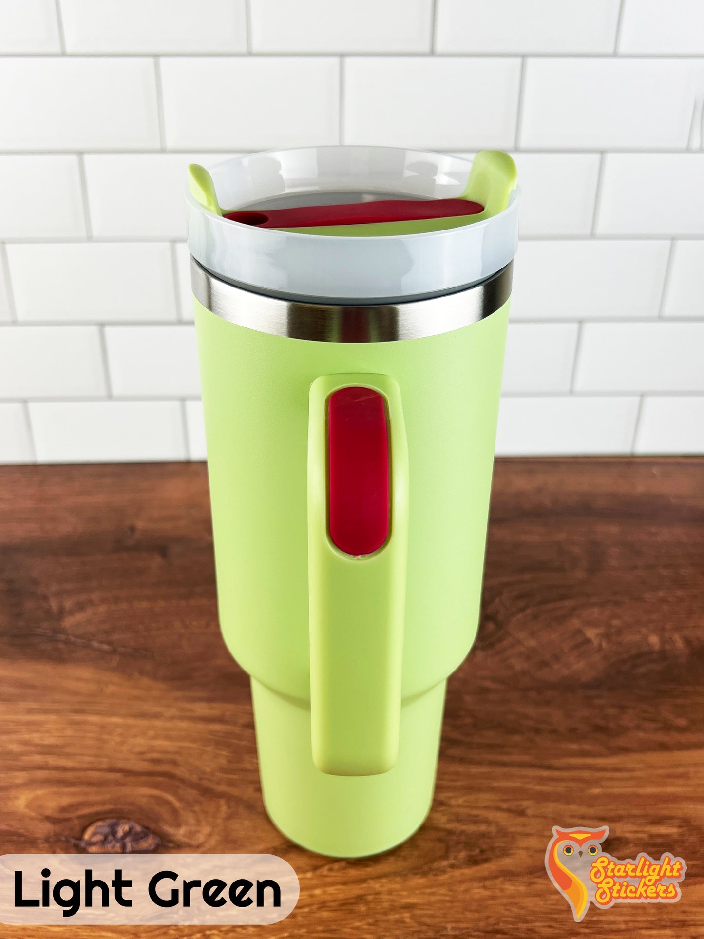 Light green tumbler showing the handle grip on a wooden table.