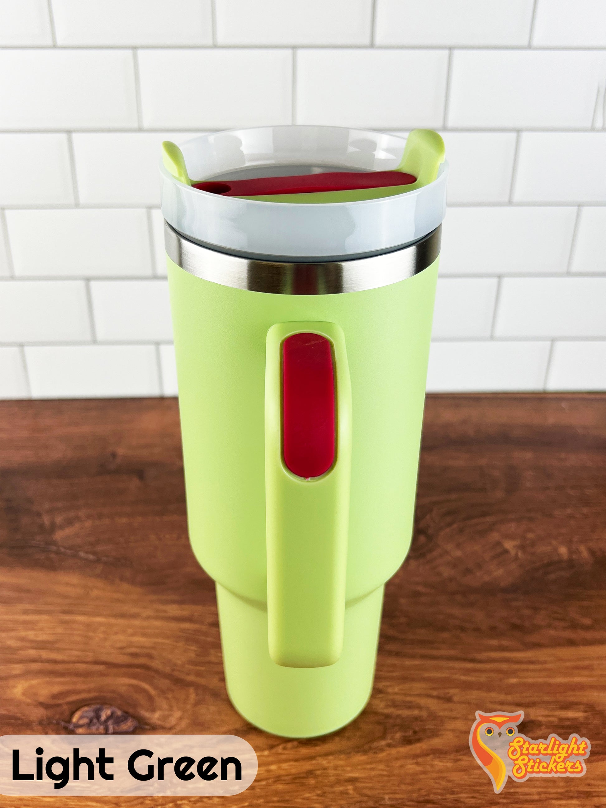 Light green tumbler showing the handle grip on a wooden table.