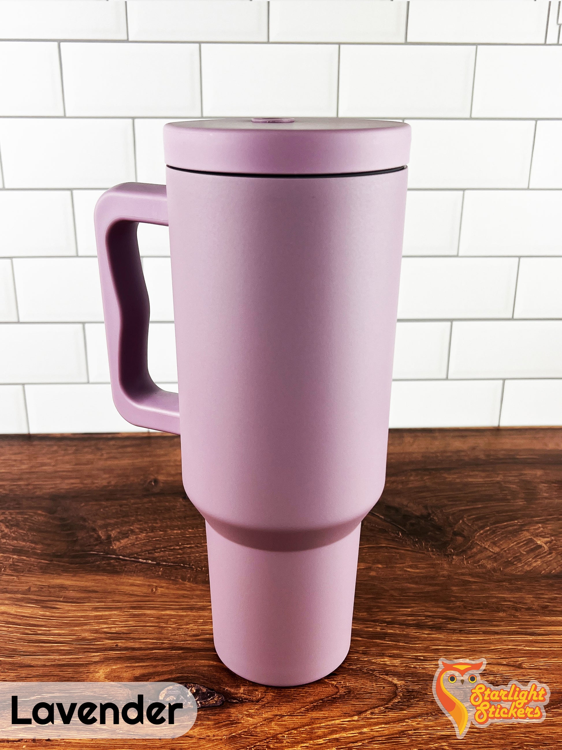 Lavender tumbler on a wooden table with a white tile background.