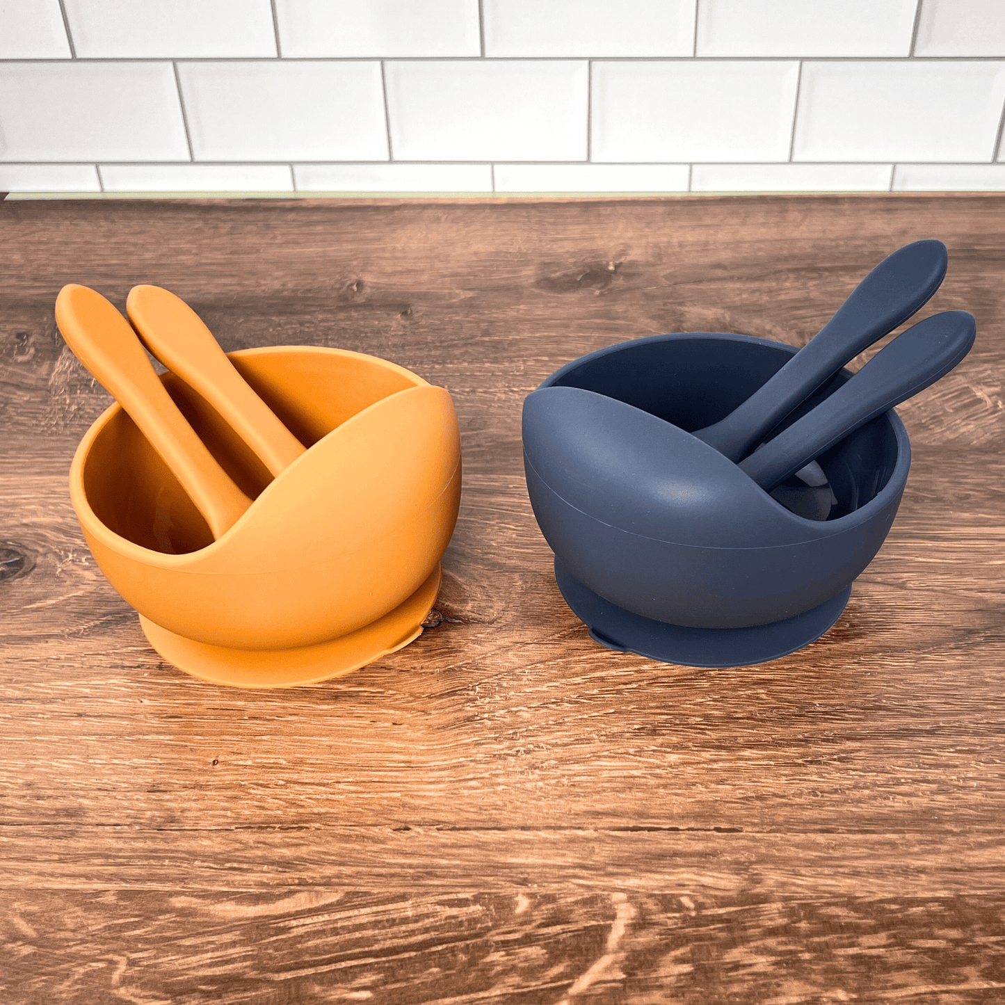 Orange and blue bowl set on a wooden table. 