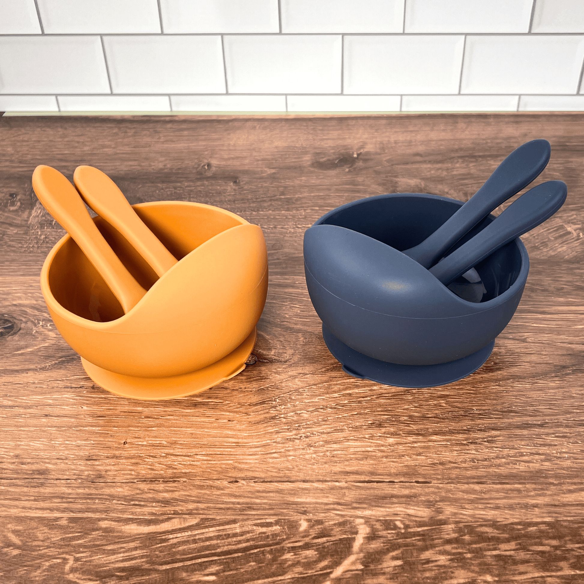 Orange and blue bowl set on a wooden table. 