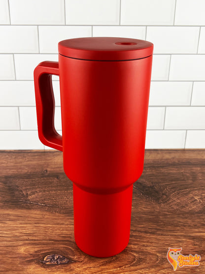 Red tumbler on wooden table and white tile background