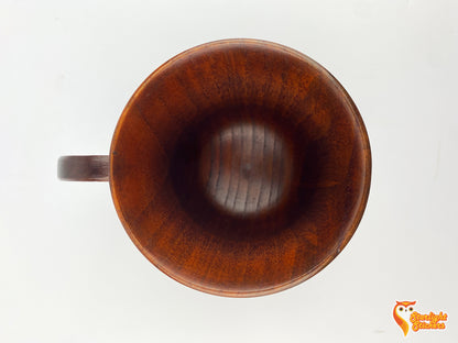 Top view of a wooden mug with a white background. 