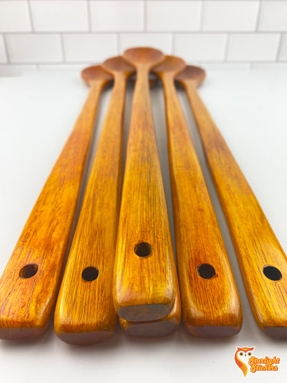 6 spoon handles laid out on a white table