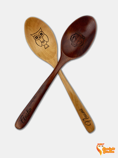 Two engraved spoons, one is dark wood the other is light wood. 