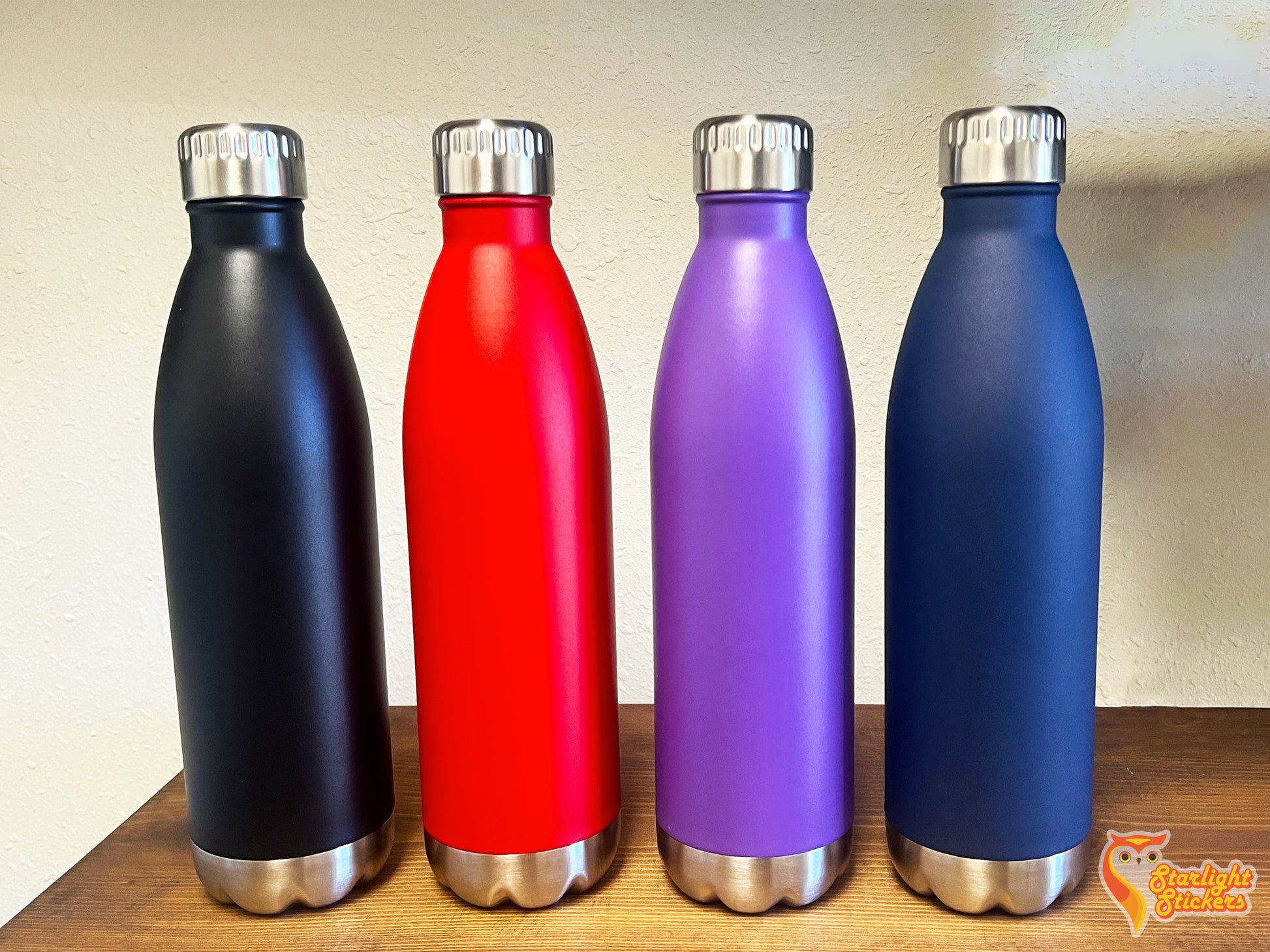 Straight on view of all color water bottles on a shelf. 