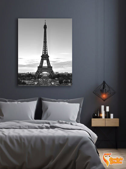 Poster of the Eiffel Tower above a bed in a bedroom. 